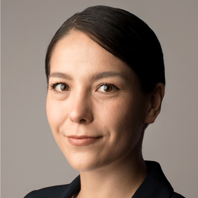 A woman smiles as she poses for a headshot.